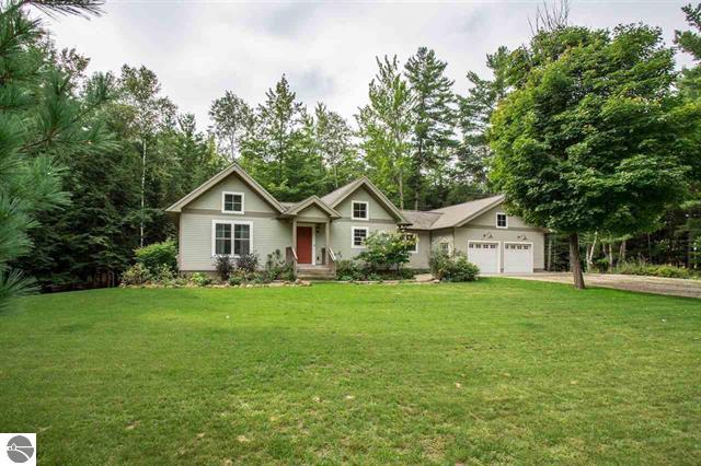 This craftsman/cottage style home sits on almost 7 private wooded acres in desirable Lake Township, 1 mile off m-22 half way between Empire and Frankfort. Drive through mature hardwoods and evergreens down a scenic, winding, county maintained road to this quality built home. Take long walks just outside your door step, a stone’s throw from the Sleeping Bear Dunes National Lake shore. Pack your beach towel and hike into the National Park down Boekeloo trail or Old Indian trail to some of the most stunning, secluded Lake Michigan beaches voted the best beaches by National Geographic. If that is not enough how about a slow float down the Platte river to the mouth of lake Michigan or go fishing on Crystal, Loon or Platte lakes, all with in a 1-3 mile radius. This amazing home is all you need to enjoy Northern Michigan at its finest. Quiet and surrounded by wild life, this is a rare find. With new energy efficient washer/dryer, french door GE stainless steel refrigerator and “Knight” Boiler purchased in 2016, you will have a care free retreat. Rustic hickory wood and tile floors, in-floor radiant heat in lower level, cherry kitchen cabinets, and 840 square foot insulated garage makes this a great year around home, summer get away or retirement dream . A must see. Seller is a licensed real estate agent in the state of Michigan as of June 9th.